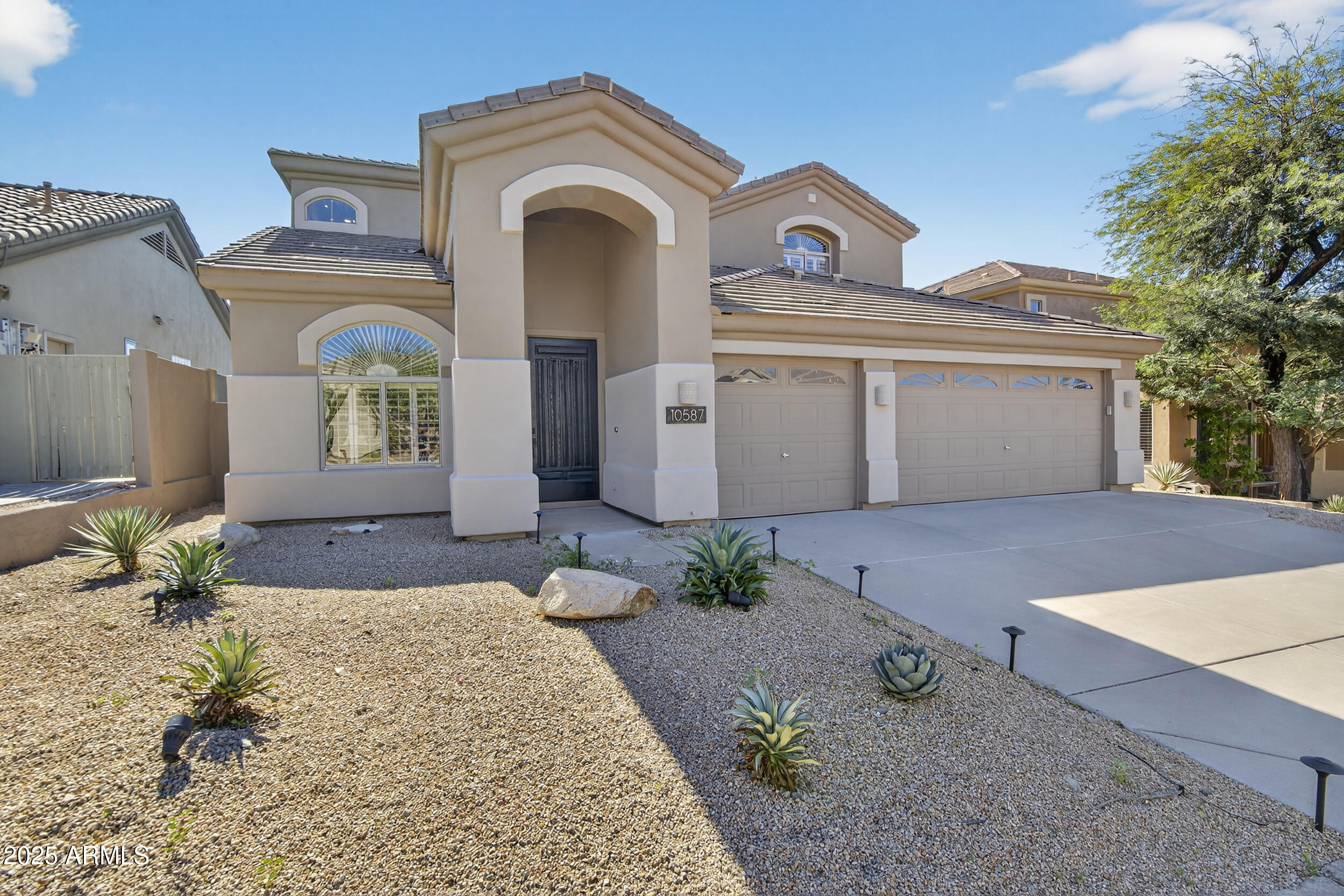 10587 East Sheena Drive Scottsdale, AZ 85255 - Photo 2 of 56 a front view of a house with garden