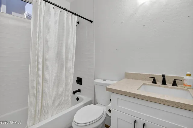 wooden floor fireplace and windows in an empty room