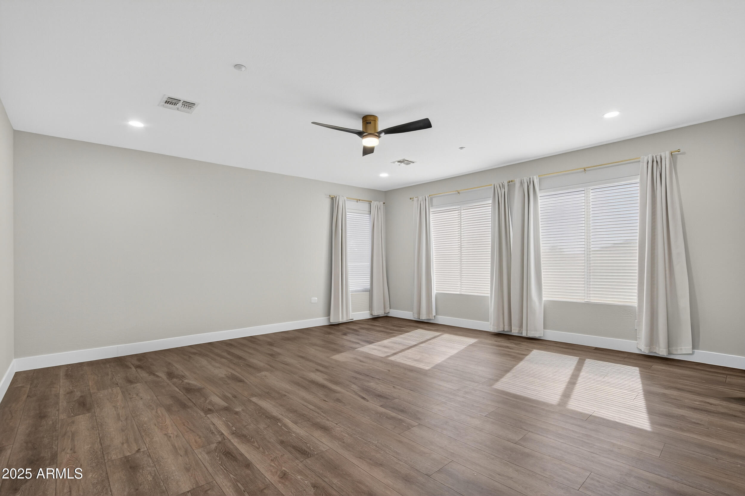 10587 East Sheena Drive Scottsdale, AZ 85255 - Photo 27 of 56 an empty room with wooden floor and windows