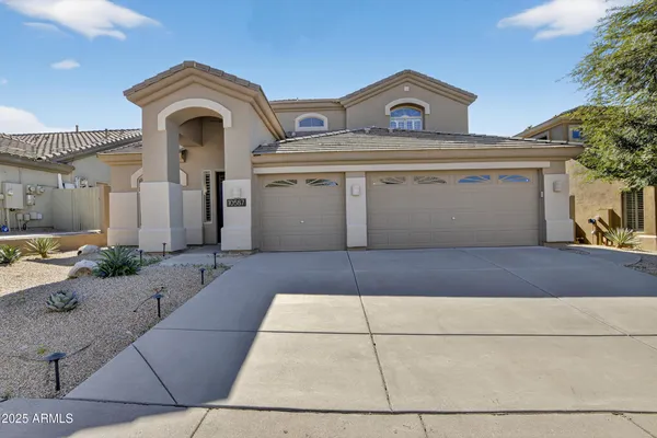 a front view of a house with a yard and garage