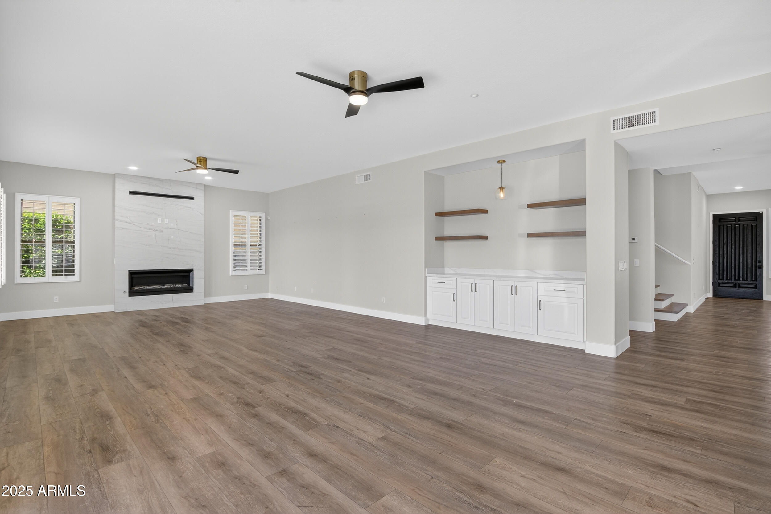 10587 East Sheena Drive Scottsdale, AZ 85255 - Photo 40 of 56 a view of empty room with wooden floor and window