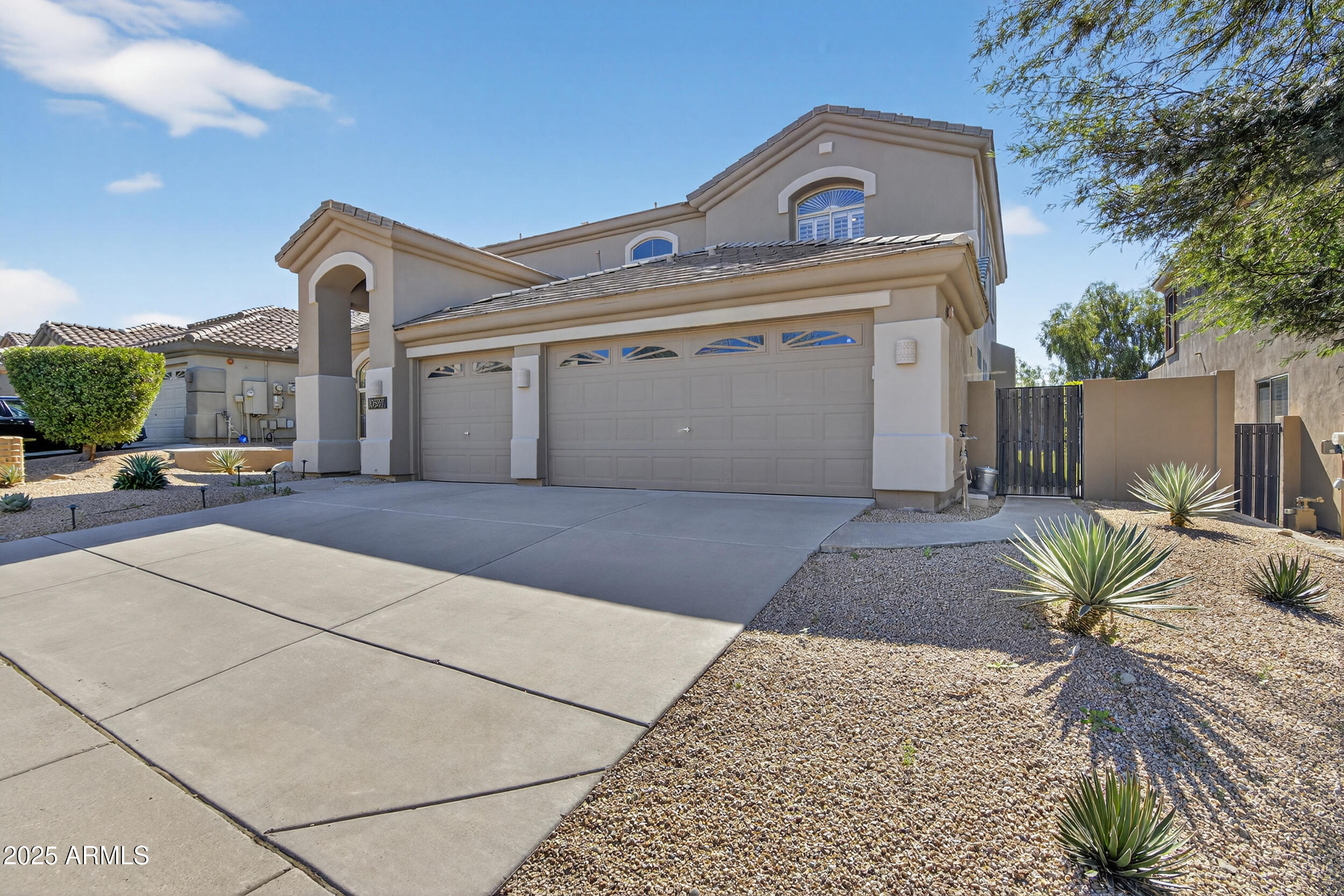 10587 East Sheena Drive Scottsdale, AZ 85255 - Photo 4 of 56 a view of a front view of a house with a garden