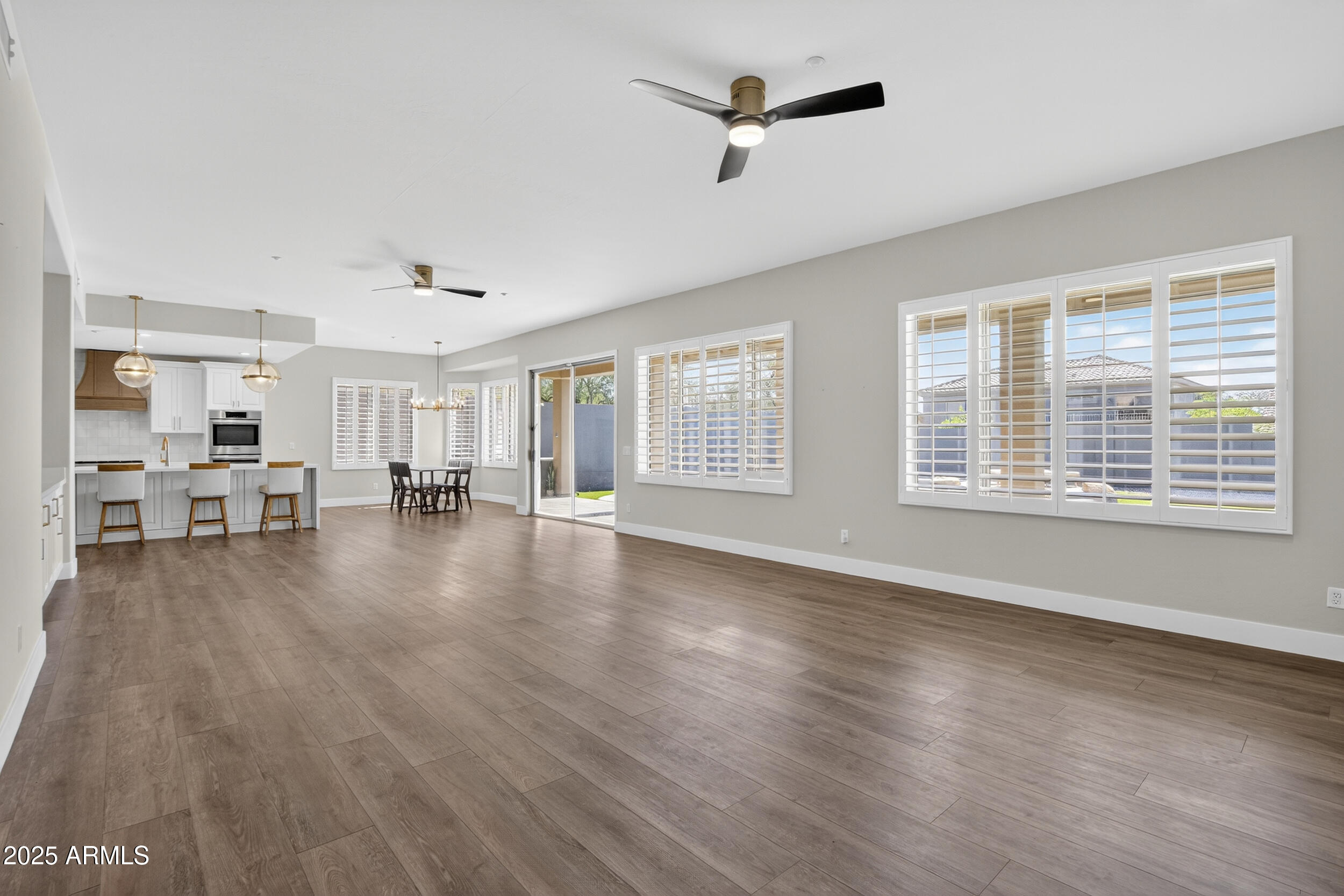 10587 East Sheena Drive Scottsdale, AZ 85255 - Photo 43 of 56 a view of a livingroom with hardwood floor and a ceiling fan