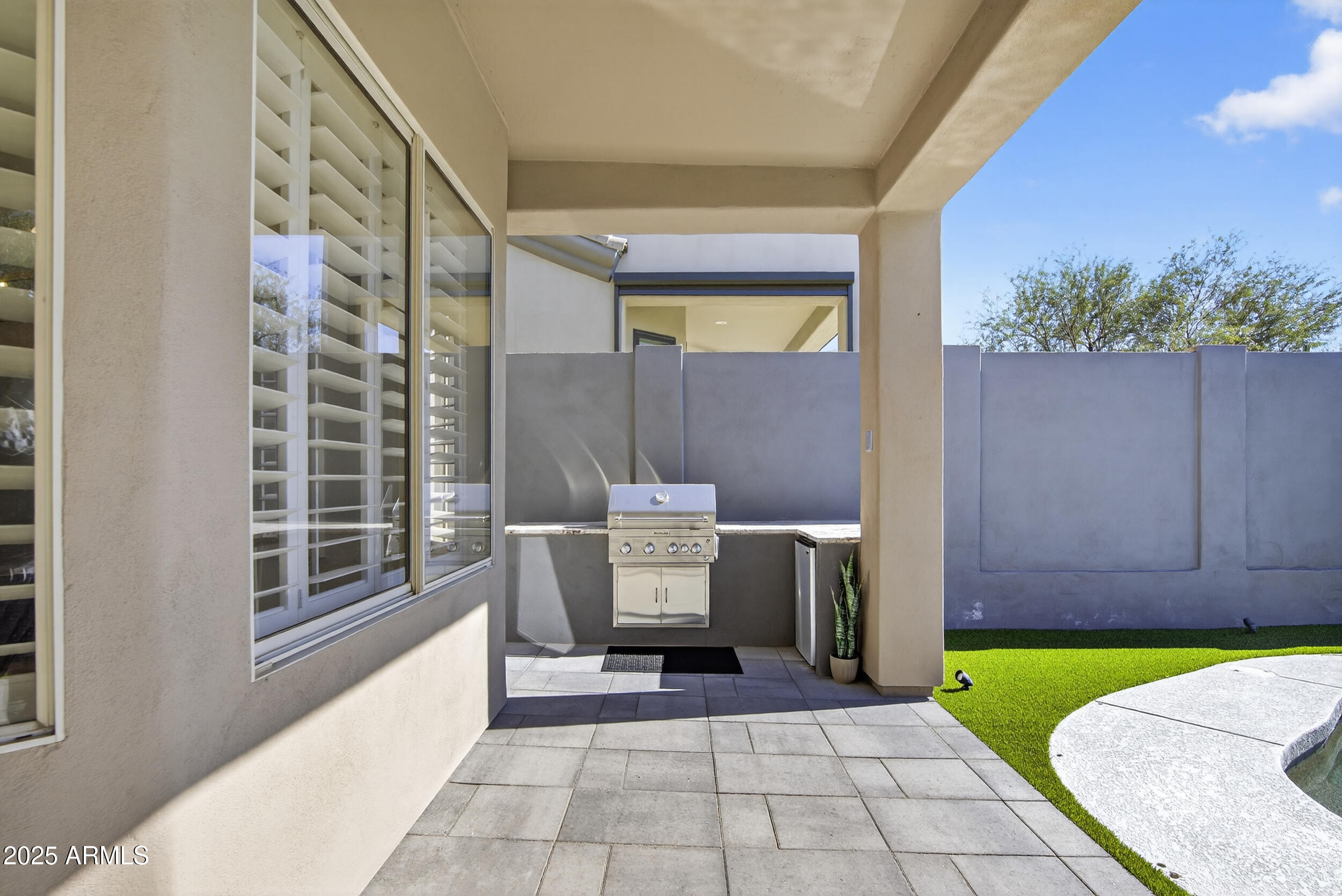 10587 East Sheena Drive Scottsdale, AZ 85255 - Photo 47 of 56 a view of a porch with a table and chairs and potted plants