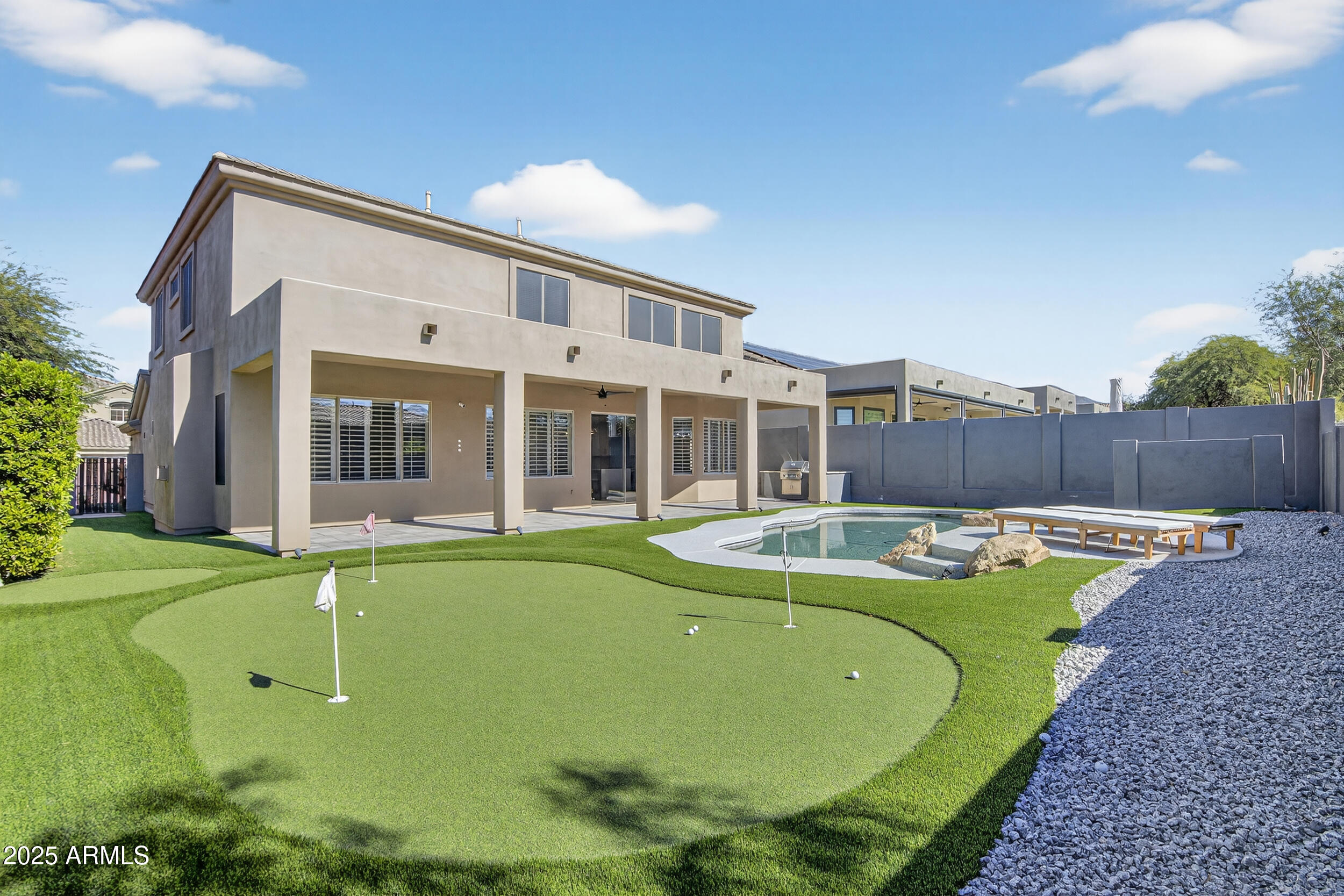 10587 East Sheena Drive Scottsdale, AZ 85255 - Photo 53 of 56 a view of a house with swimming pool and a yard