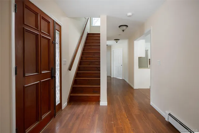 a view of a hallway with wooden floor and entryway