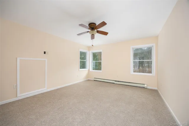 a view of room with a ceiling fan and window
