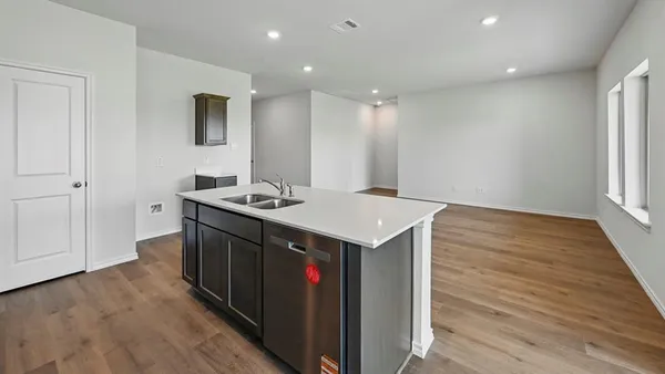 a kitchen with a sink and cabinets