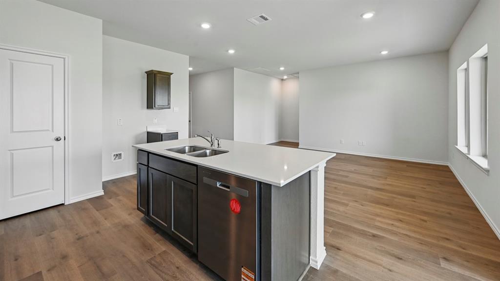 4607 Enclave Drive Sanger, TX 76266 - Photo 19 of 34 a kitchen with a sink and cabinets