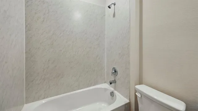 a bathroom with a toilet and bathtub