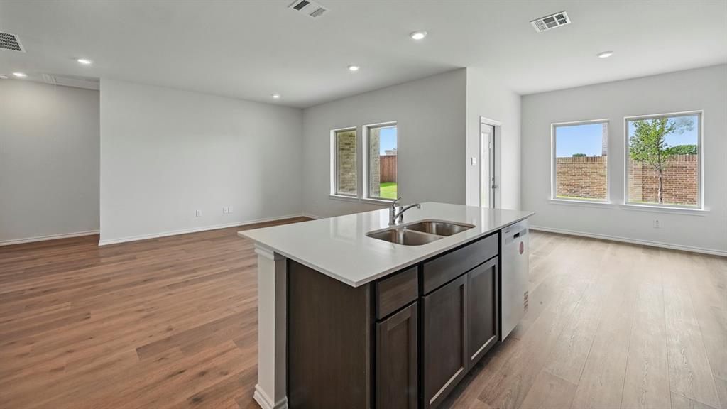 4607 Enclave Drive Sanger, TX 76266 - Photo 25 of 34 a kitchen with a sink cabinets and wooden floor