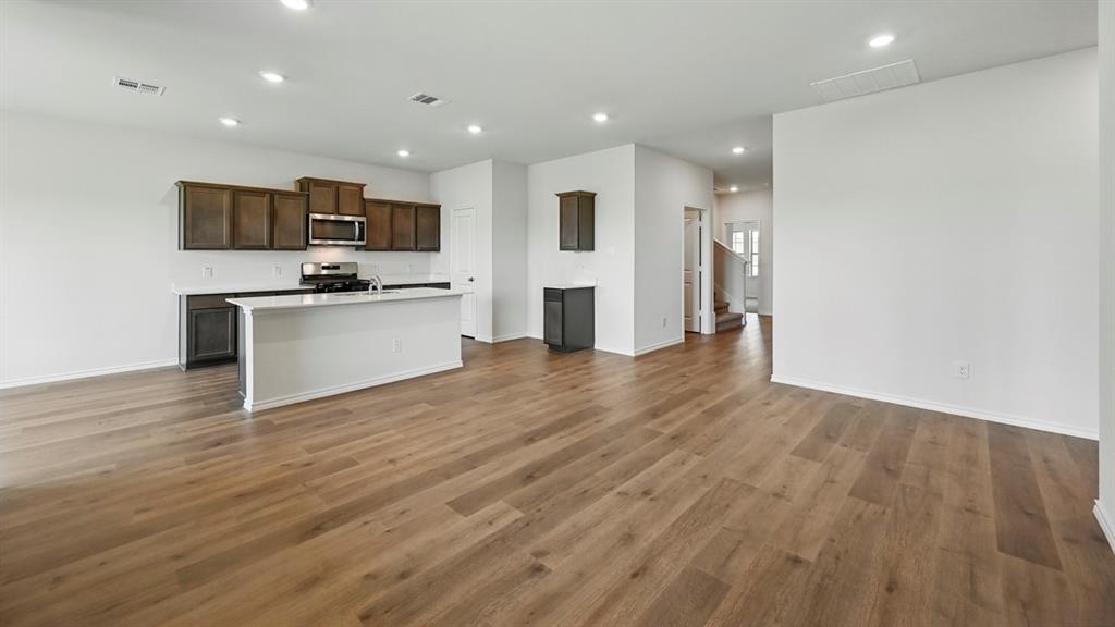4607 Enclave Drive Sanger, TX 76266 - Photo 30 of 34 a view of kitchen with stainless steel appliances refrigerator stove microwave and oven