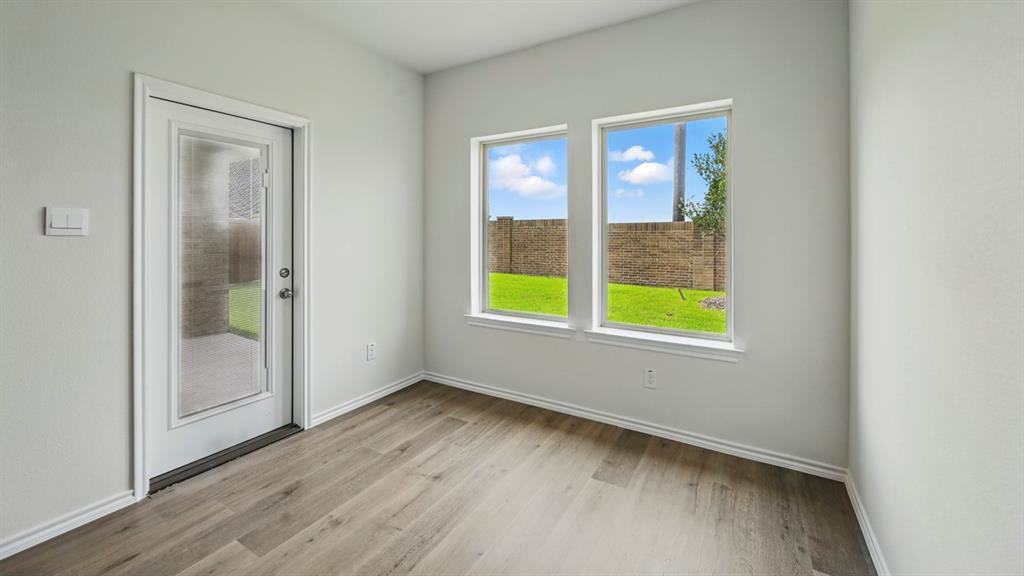 4607 Enclave Drive Sanger, TX 76266 - Photo 32 of 34 a view of an empty room with wooden floor and a window