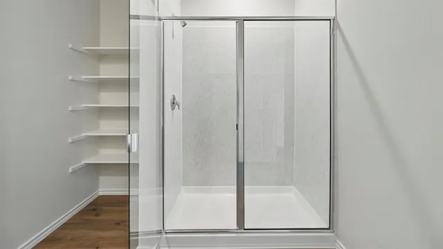 a bathroom with a glass shower door