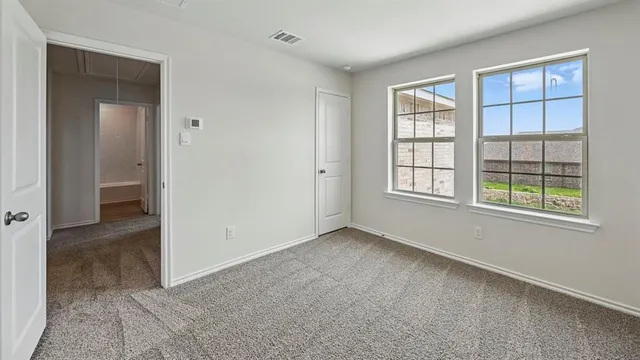 an empty room with windows and closet