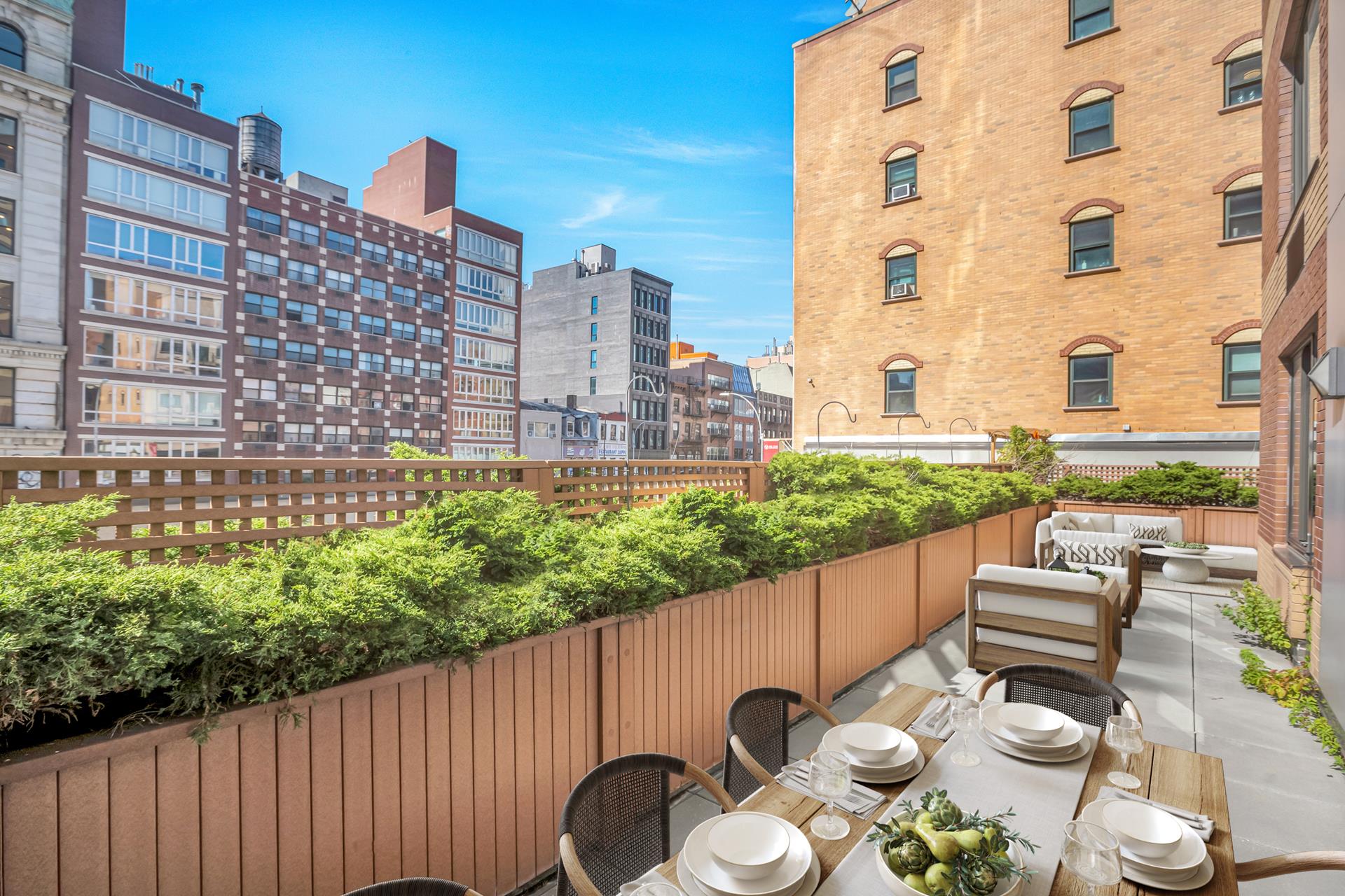 199 Bowery, Unit 2A Manhattan, NY 10002 - Photo 1 of 10 a patio with table and chairs with potted plants