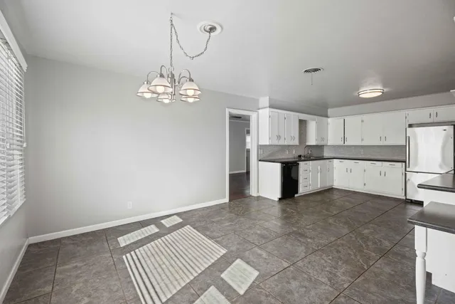 a view of a kitchen with a sink cabinets and wooden floor
