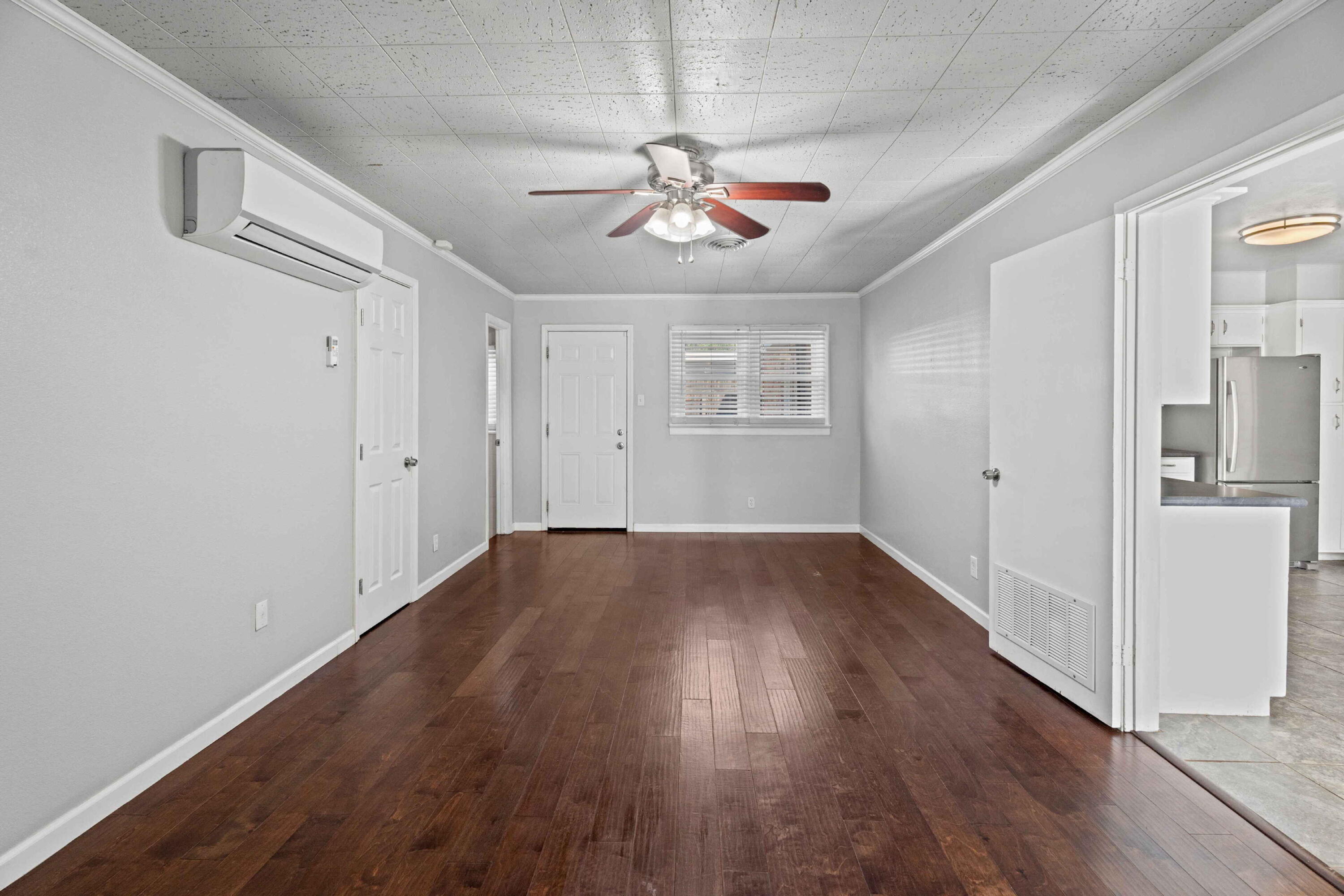 3520 42nd Street Lubbock, TX 79413 - Photo 6 of 12 wooden floor in an empty room with a window