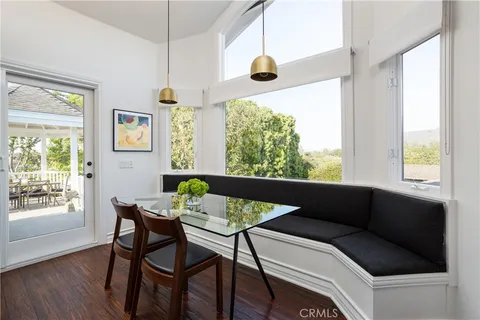 a view of a dining room with furniture and a chandelier