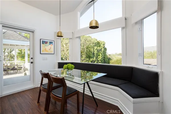 a view of a dining room with furniture and a chandelier