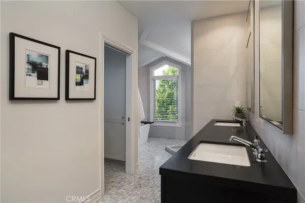 a white bath tub sitting in a bathroom next to a window