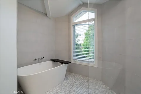 a bathroom with a granite countertop sink a mirror and a shower