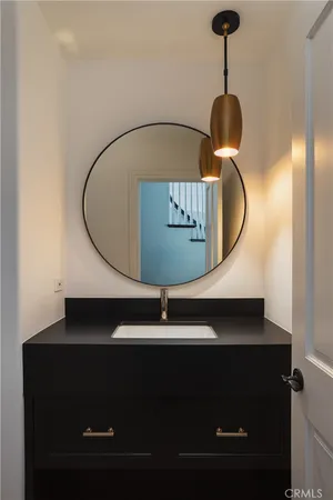 a living room with furniture a flat screen tv and a window