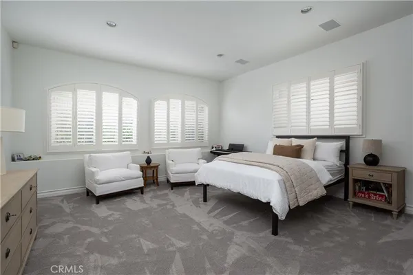 a bathroom with a granite countertop sink mirror and toilet