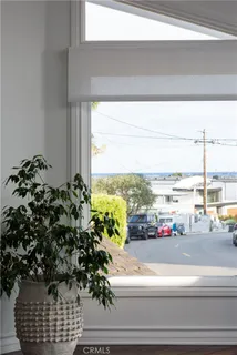 a picture of a floor to ceiling window and an ocean view