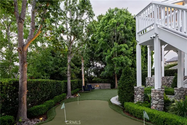 a front view of a house with garage and plants
