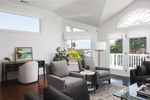 a living room with furniture a wooden floor and a large window