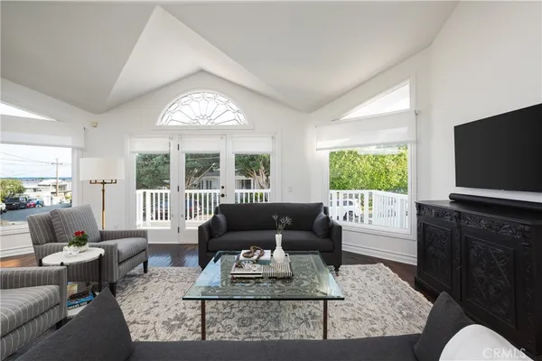 a living room with furniture a large window and a flat screen tv