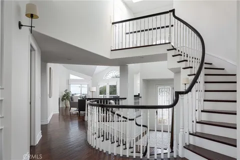 a view of entryway with wooden floor and windows