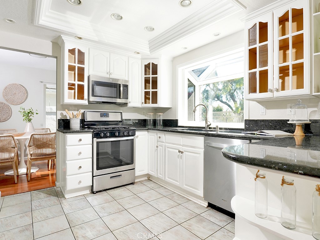 25102 Danabirch Dana Point, CA 92629 - Photo 17 of 53 a kitchen with stainless steel appliances granite countertop a stove a sink and a microwave
