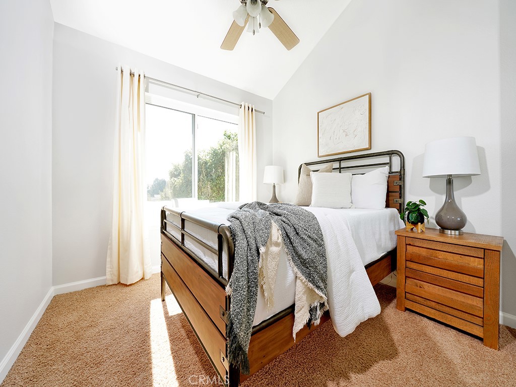 25102 Danabirch Dana Point, CA 92629 - Photo 21 of 53 a bed room with a bed and a chandelier