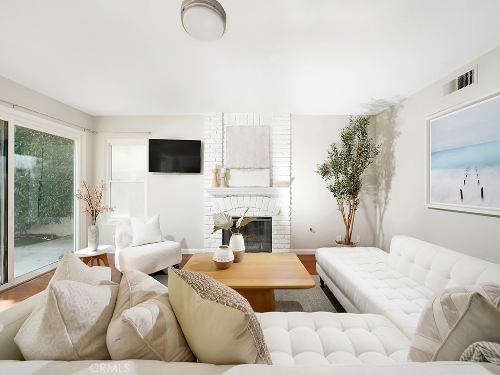 25102 Danabirch Dana Point, CA 92629 - Photo 7 of 53 a bedroom with furniture and a fireplace