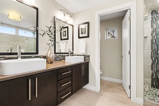 a bathroom with a double vanity sink and a mirror