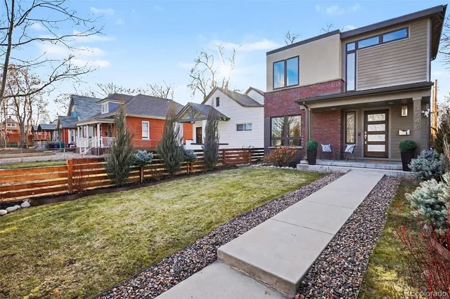 a front view of a house with a yard table and chairs