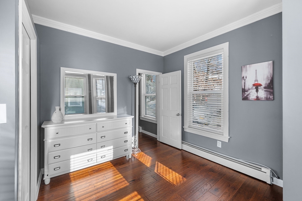 5-7 Vernon Street, Unit 1 Haverhill, MA 01835 - Photo 14 of 22 wooden floor in a room with window and cabinet