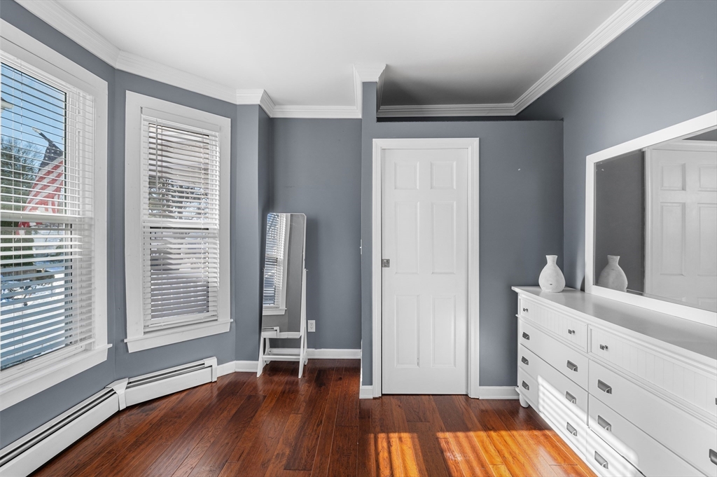 5-7 Vernon Street, Unit 1 Haverhill, MA 01835 - Photo 15 of 22 a view of room with window and wooden floor