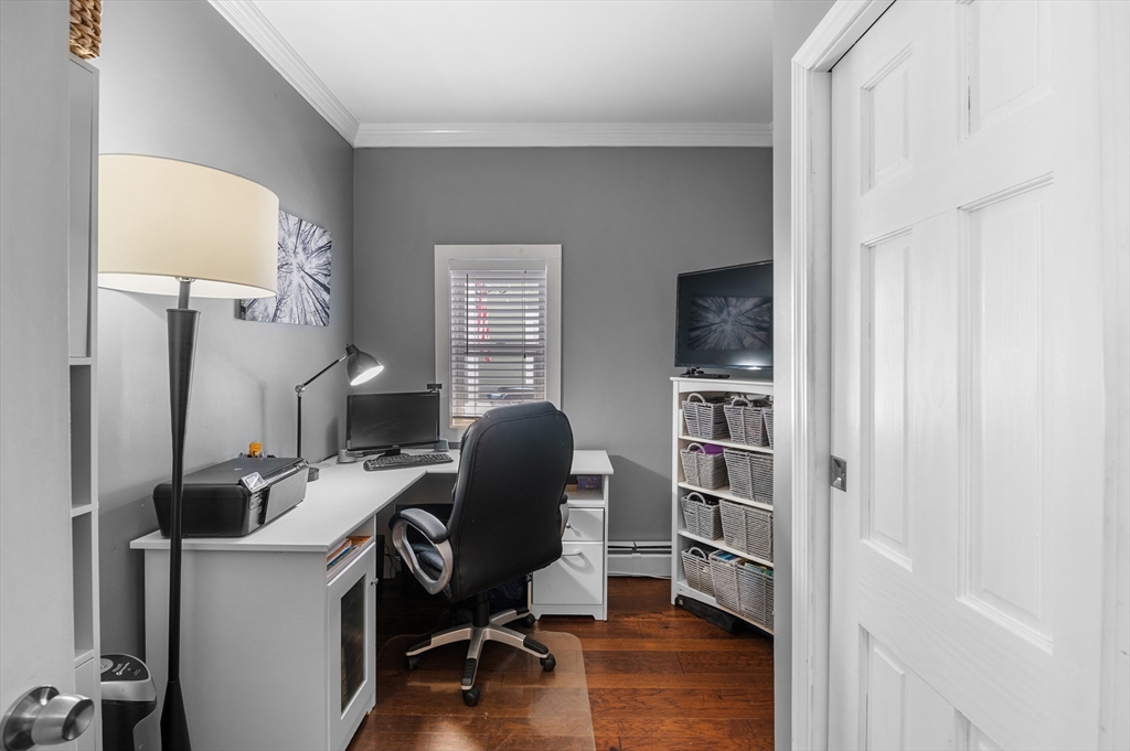 5-7 Vernon Street, Unit 1 Haverhill, MA 01835 - Photo 16 of 22 a view of a workspace with furniture and a window