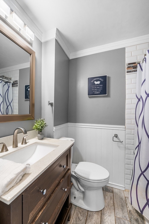 5-7 Vernon Street, Unit 1 Haverhill, MA 01835 - Photo 18 of 22 a bathroom with a granite countertop toilet sink and mirror