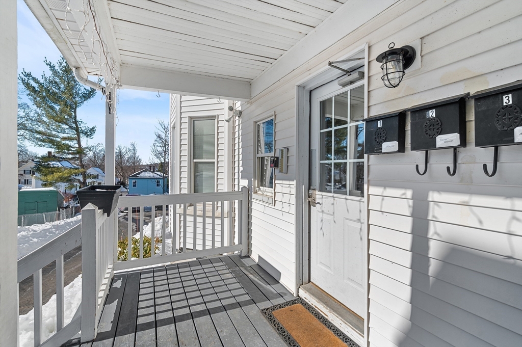 5-7 Vernon Street, Unit 1 Haverhill, MA 01835 - Photo 19 of 22 a view of a porch with wooden floor