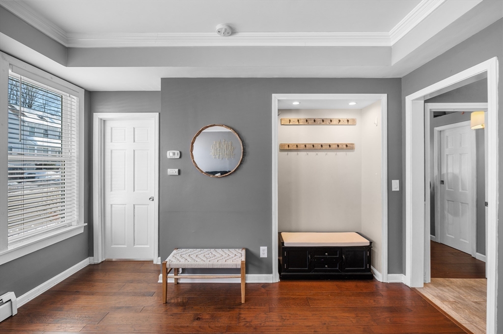 5-7 Vernon Street, Unit 1 Haverhill, MA 01835 - Photo 6 of 22 a bedroom with a bed and a window