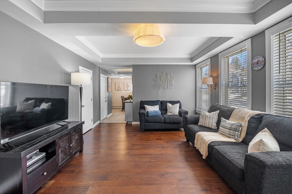 5-7 Vernon Street, Unit 1 Haverhill, MA 01835 - Photo 8 of 22 a living room with furniture and a flat screen tv