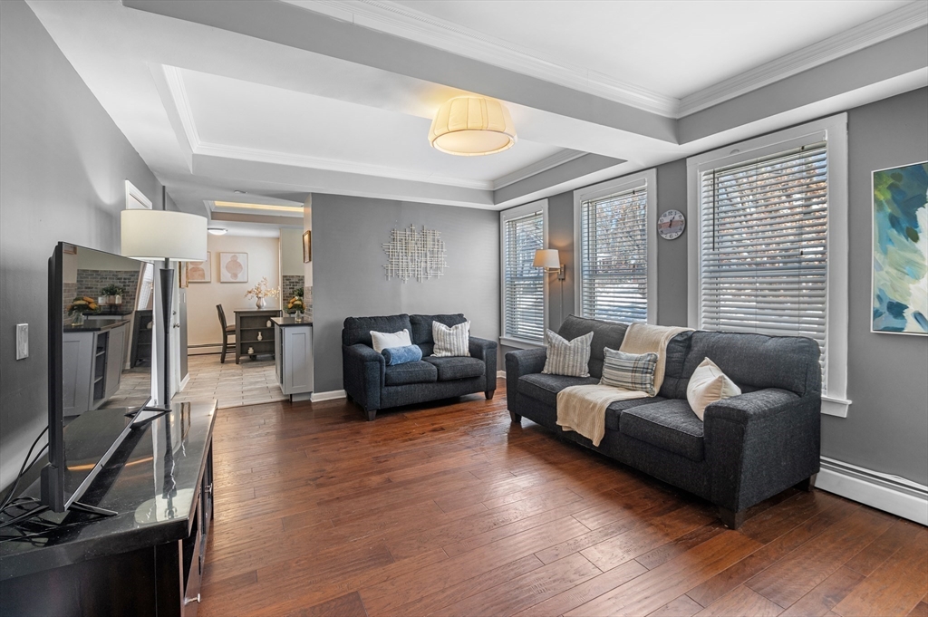 5-7 Vernon Street, Unit 1 Haverhill, MA 01835 - Photo 9 of 22 a living room with furniture and a flat screen tv