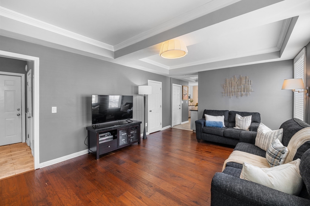 5-7 Vernon Street, Unit 1 Haverhill, MA 01835 - Photo 10 of 22 a living room with furniture and a flat screen tv