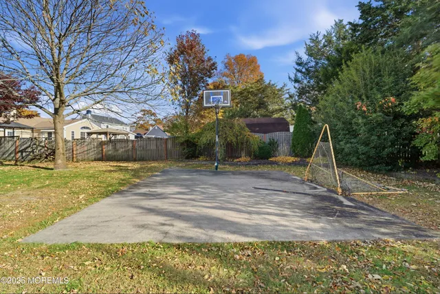 a view of yard with swimming pool and trees