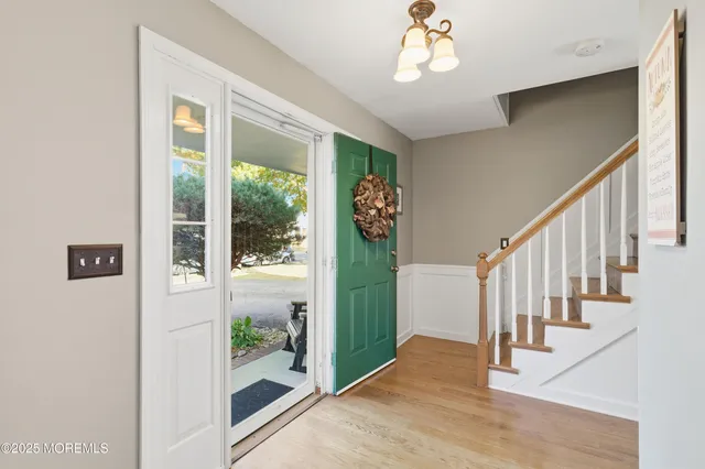 a view interior of a house with wooden floor windows and a ceiling fan