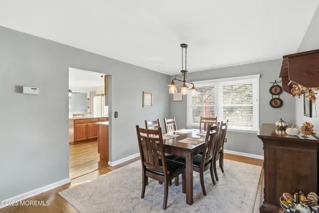 a view of a dining room with furniture and window